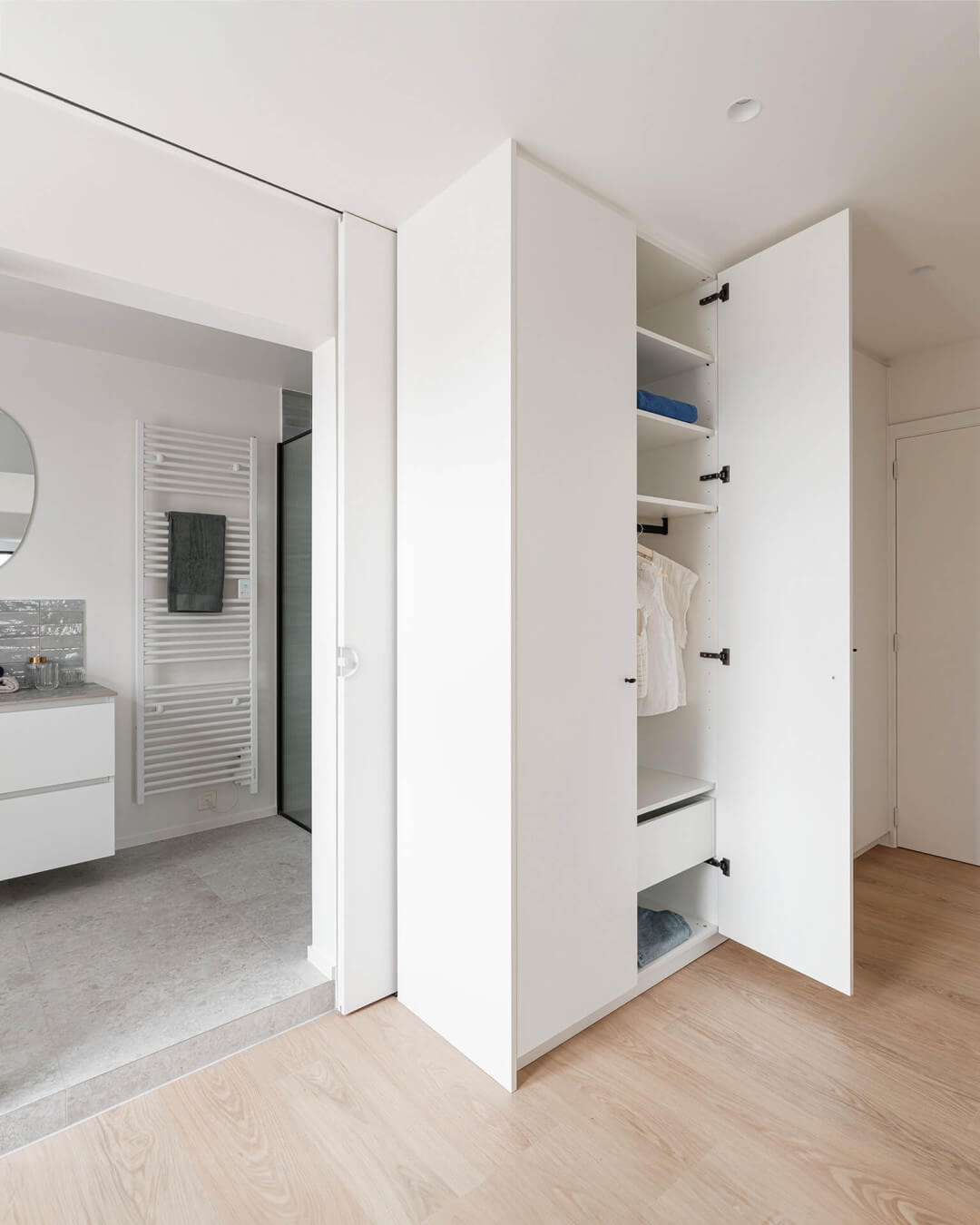Walk-in dressing room in teenager's room in sleek white