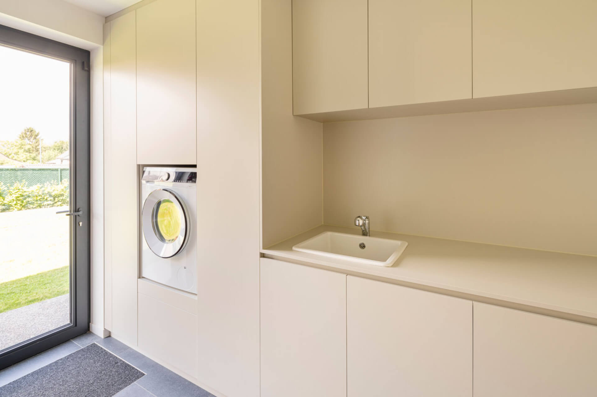 Laundry room with custom cabinets and built-in washing machine, in the color Turtle Grey