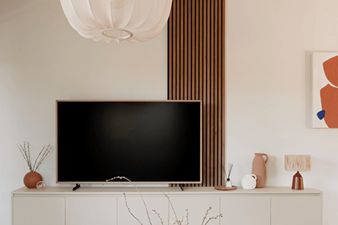 Acoustic wall panel in a warm walnut shade behind a TV unit in Turtle Grey
