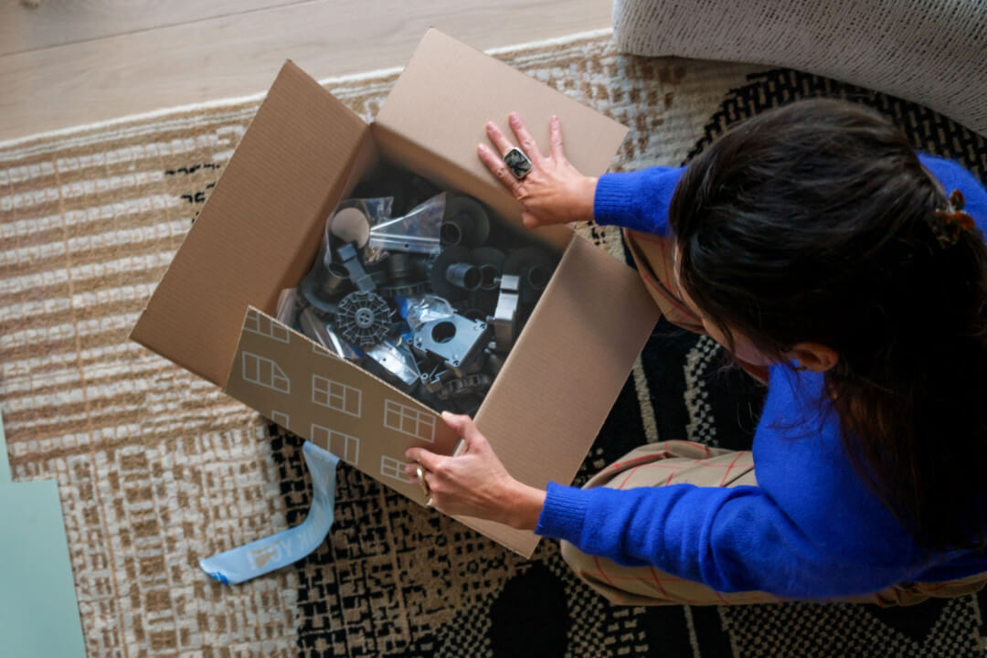 Person opening box with construction fittings