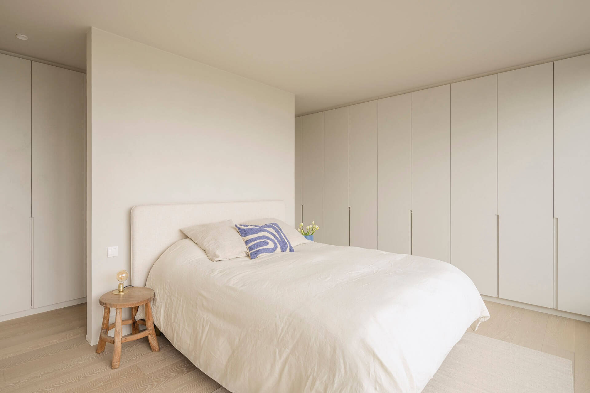 Slaapkamer met een dressingkast in een hoek op maat gemaakt en voorzien van een structuurverf