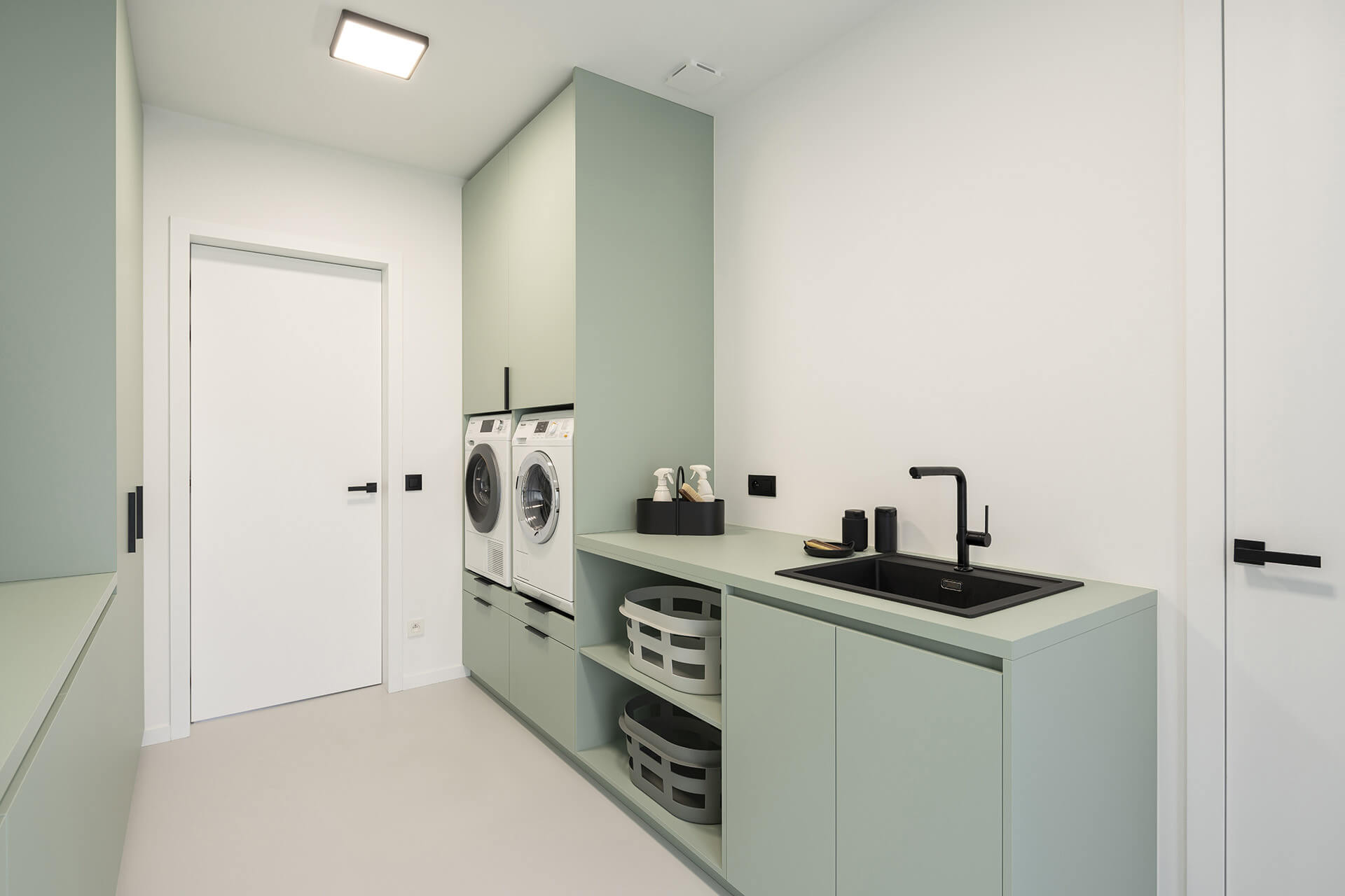 Laundry room with bespoke washroom and storage cupboard