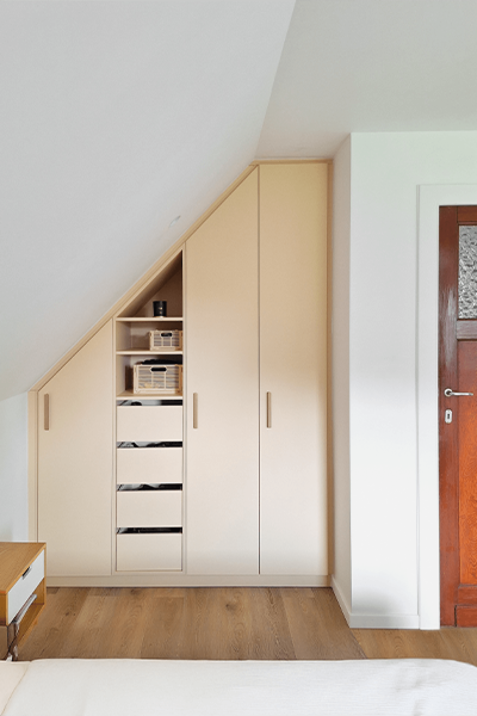 White custom-made slanted dressing cabinet with brass bar handles